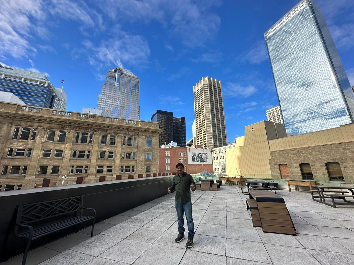 Raja Jeyachandran, an IT consultant that relocated from India to Calgary, Alberta with MobSquad, takes in the beautiful downtown views from MobSquad’s head office in Calgary.