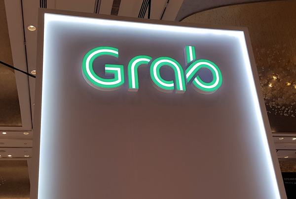 Singapore's Grab raises annual revenue forecast, shares jump